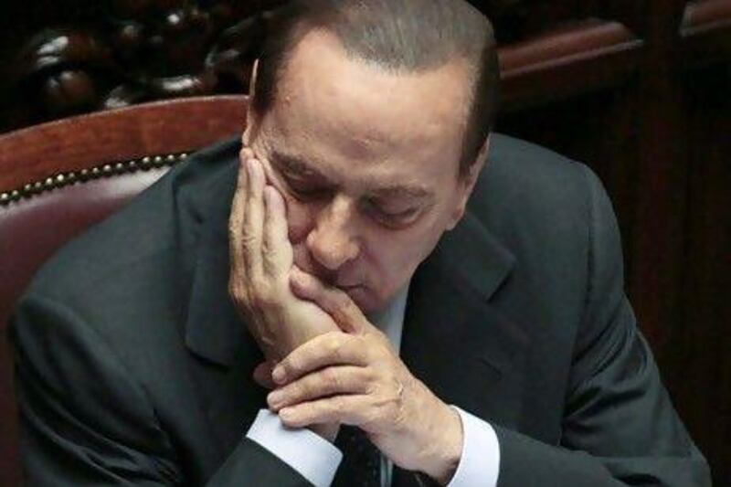 Italian Premier Silvio Berlusconi reacts prior to the start of a voting session in parliament. AP Photo