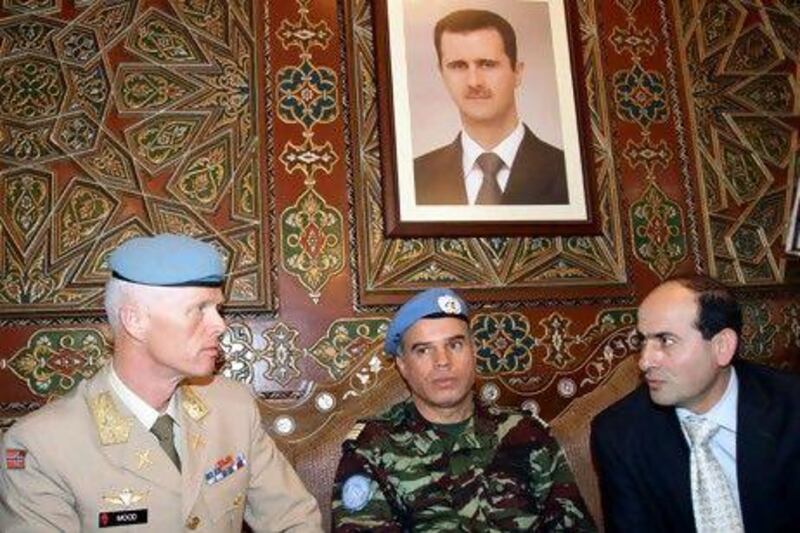 Upon arrival in Damascus Maj Gen Robert Mood, left, speaks with the Syrian foreign ministry employee Mohammed Al Mohammed, right, and Col Ahmed Himmiche, the UN advance team leader.