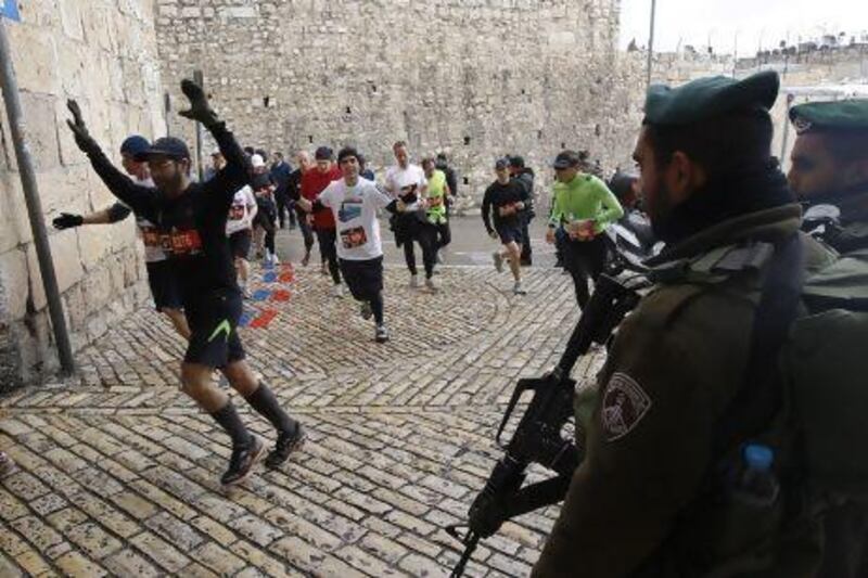 Israeli border policemen stand guard as runners take part in the Jerusalem Winner Marathon last year. Ronen Zvulun / AFP