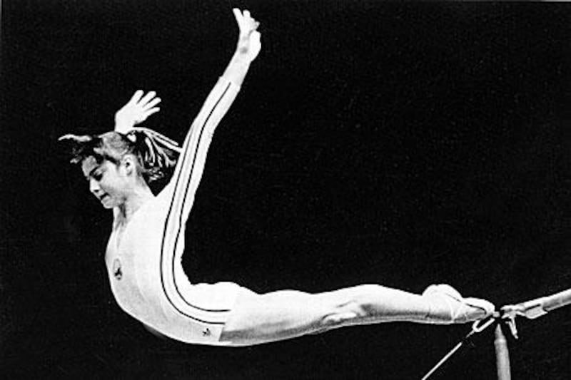 Nadia Comaeci, the 14-year-old Romanian gymnast, flies out of the uneven bars to score a perfect 10 during the women's team competition in the Olympic Games in Montreal 1976.