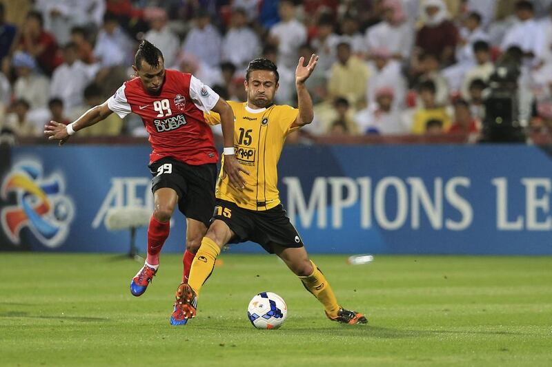 Al Ahli’s Ciel, left, tries to steal the ball from Omid Ibrahim of Sepahan during their match at Rashid Stadium in Dubai on Tuesday night. Sarah Dea / The National

