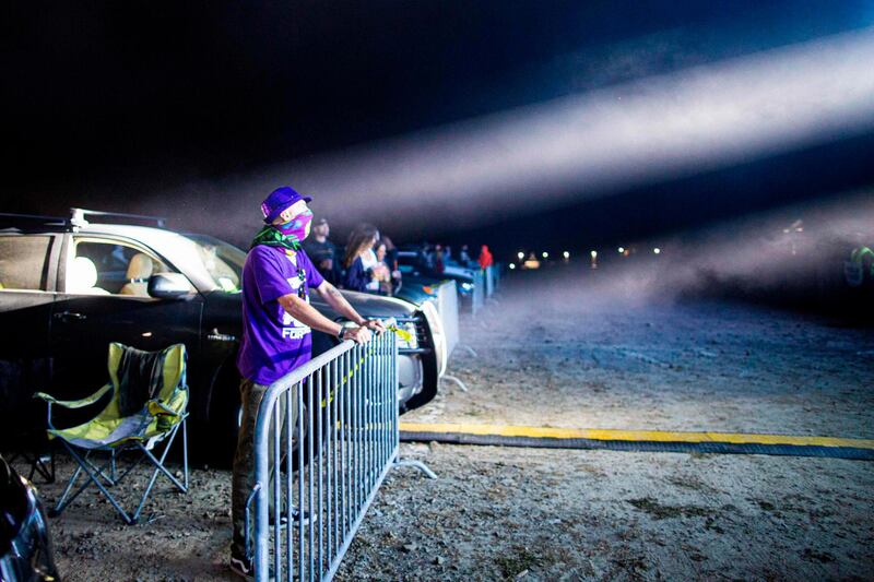 Attendees watch the The Disco Biscuits perform during the Montage Mountain rave, night of electronic music where the party-goers are in or around their cars, owing to the coronavirus pandemic, in Scranton, Pennsylvania.  AFP