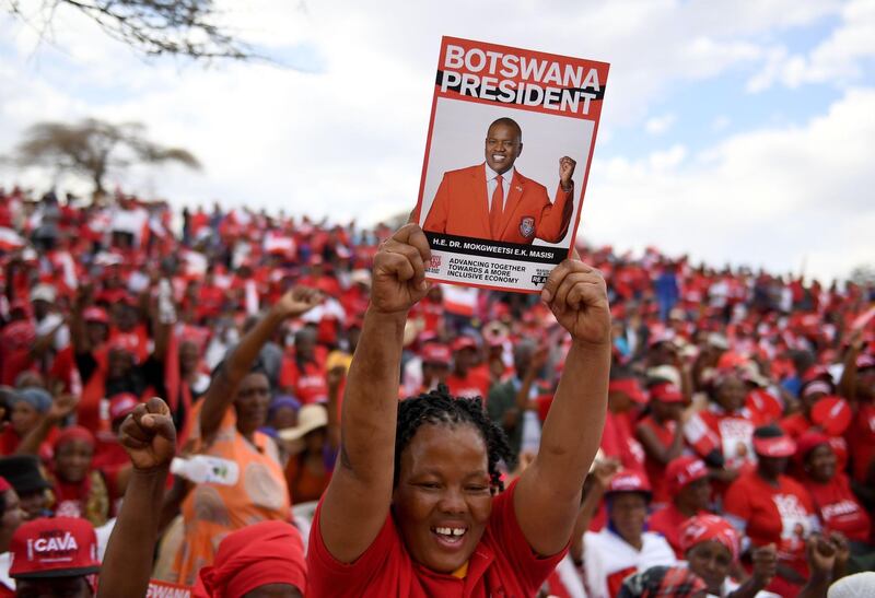 A Botswana Democratic Party supporter holds up a poster during an election campaign rally. AFP