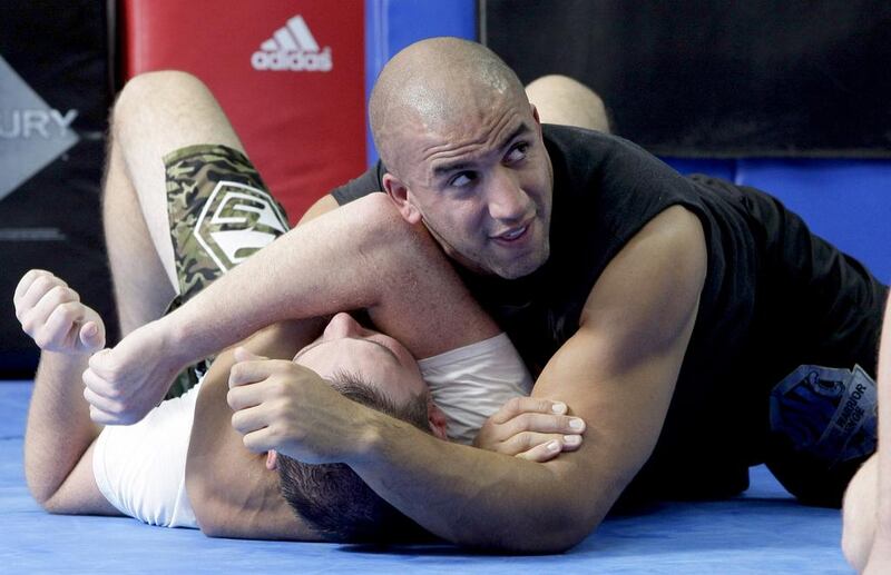 Instructor Tam Khan grapples with one of his students during a class in Dubai. Jeffrey E Biteng / The National