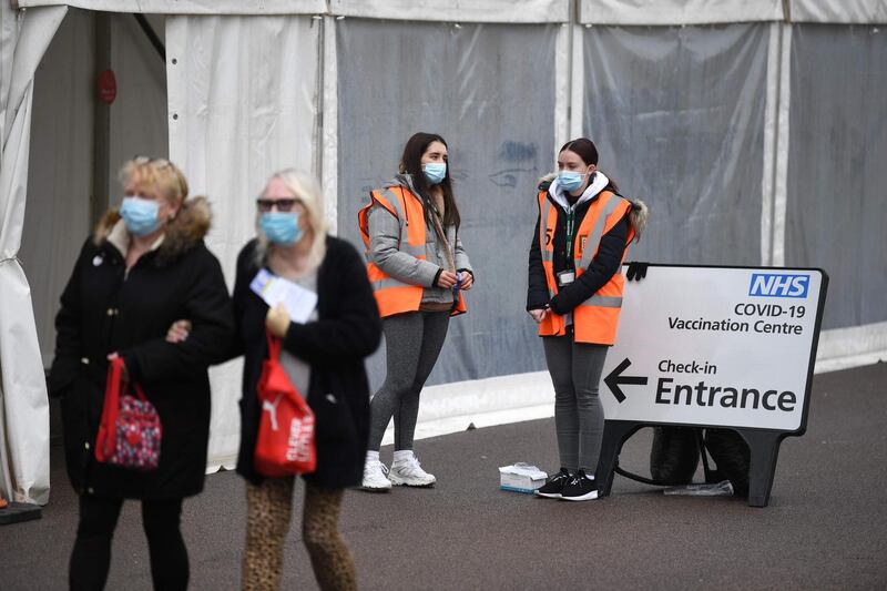 Volunteers stand outside a temporary vaccination hub at the Colchester Community Stadium in Colchester. AFP