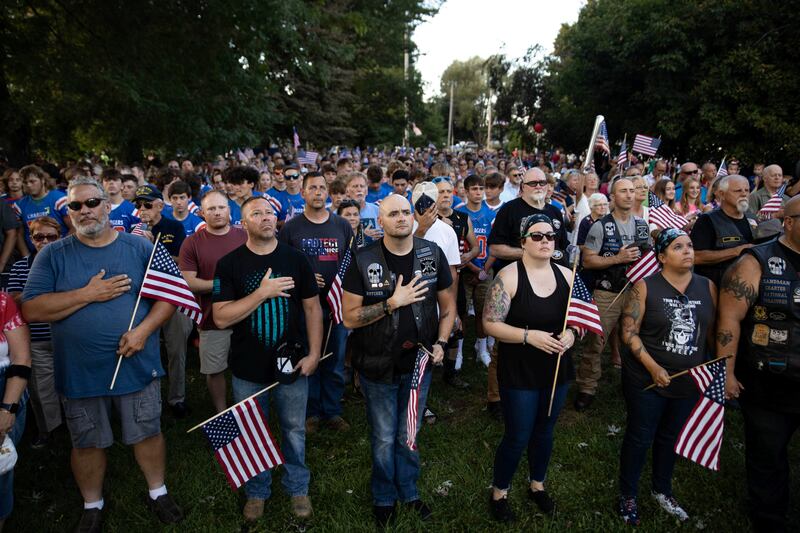 People sing the national anthem at the vigil for Soviak. Reuters