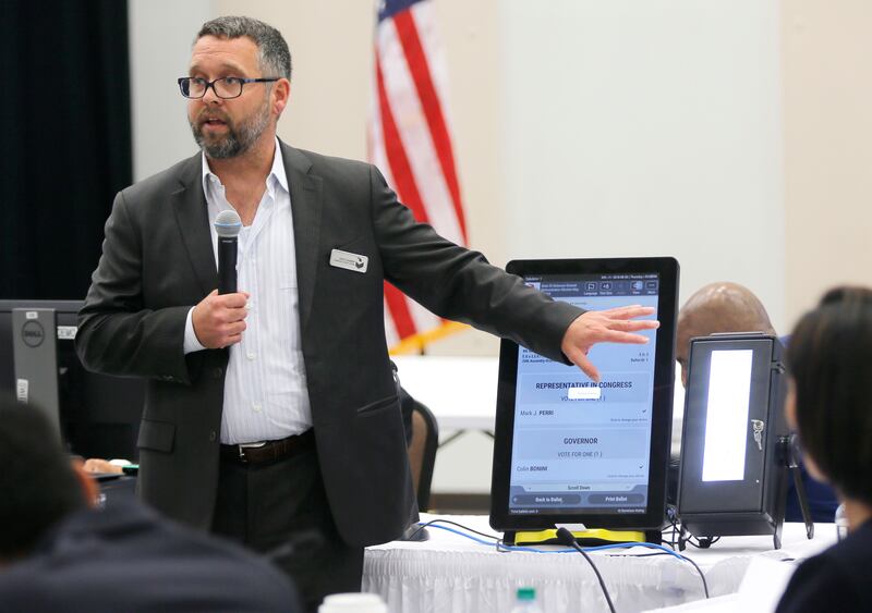 Eric Coomer from Dominion Voting demonstrates his company's touchscreen tablet in Grovetown, Georgia. Atlanta Journal-Constitution via AP