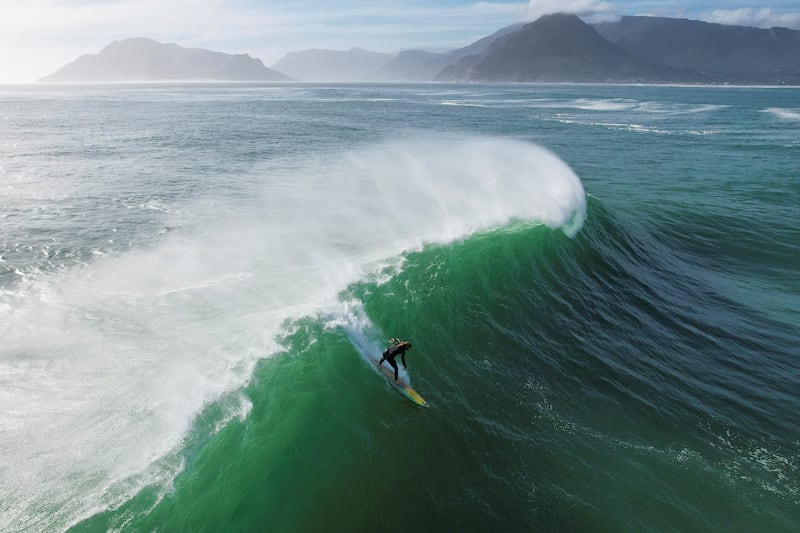 A surfer rides a wave at the Cape Peninsula in Cape Town, South Africa. Reuters