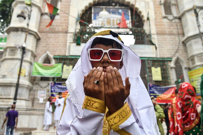 A young Muslim devotee offers prayers during the Eid al-Adha or the 'Festival of Sacrifice, in Ajmer.