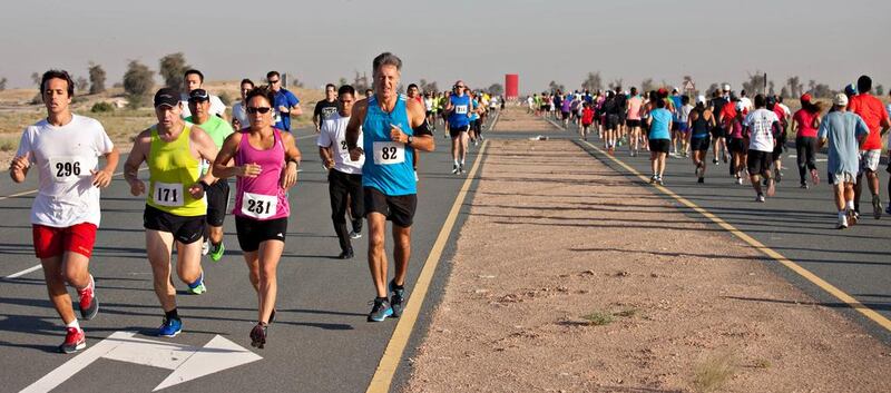 Participants in the Dubai Desert Road Run, one of a series that allows runners to track their progress during the year. Clint McLean for The National