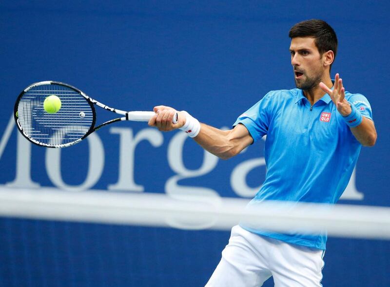 Novak Djokovic of Serbia hits a return to Stan Wawrinka of Switzerland. Kena Betancur / AFP