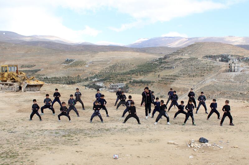 Boys take part in an open-air training session with martial arts coach Hassan Mansour in the Barada Valley, Syria. All photos: Reuters