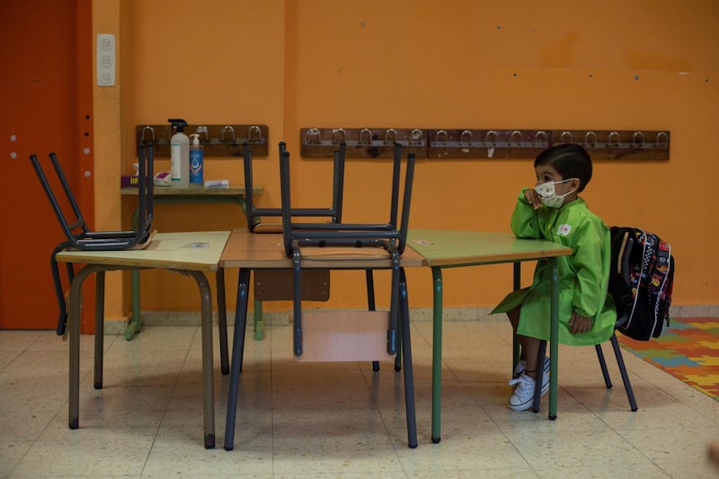 A child sits down during his first on-site day at Albino Nunez school after months of lockdown in Ourense, Spain. EPA