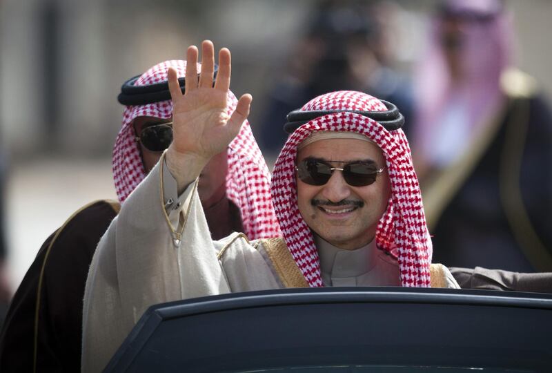 FILE - In this Feb. 4, 2014 file photo, Saudi billionaire Prince Alwaleed bin Talal, waves as he arrives at the headquarters of Palestinian President Mahmoud Abbas in the West Bank city of Ramallah. Alwaleed bin Talal was released on Saturday, Jan. 27, 2018,  from the luxury hotel where he has been held since November, according to three of his associates, marking the end of a chapter in a wide-reaching anti-corruption probe that has been shrouded in secrecy and intrigue. The prince, 62, had been the most well-known and prominent detainee held at the Ritz-Carlton hotel in the Saudi capital, Riyadh, since Nov. 4, when his much younger cousin, Crown Prince Mohammed bin Salman, ordered the surprise raids against prominent princes, businessmen, ministers and military officers.  (AP Photo/Majdi Mohammed, File)