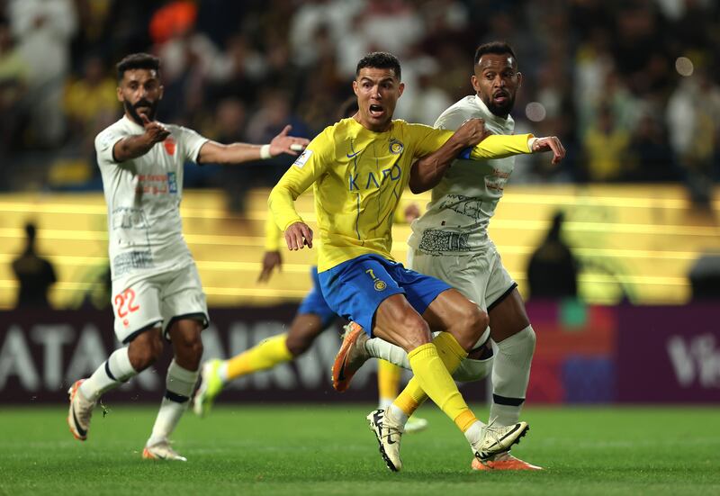 Al Nassr's Cristiano Ronaldo battles for possession with Mukhir Al Rashidi of Al Fayha during their AFC Champions Leauge round of 16 match. Getty Images