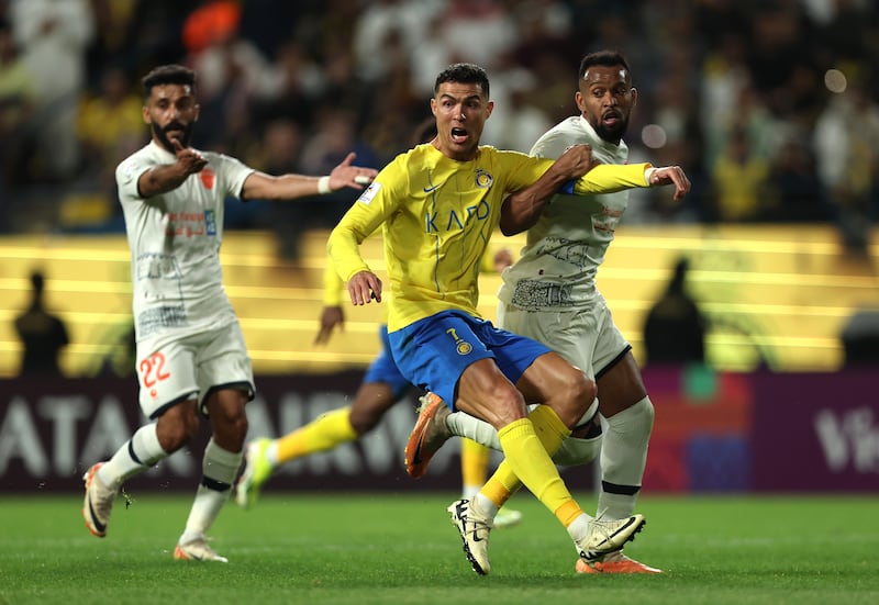 Al Nassr's Cristiano Ronaldo battles for possession with Mukhir Al Rashidi of Al Fayha during their AFC Champions Leauge round of 16 match. Getty Images