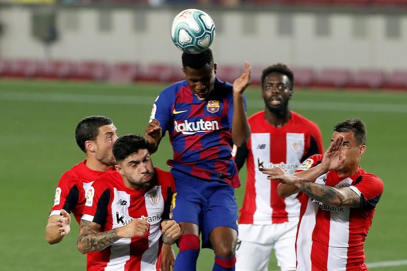 Barcelona's Ansu Fati (C) heads the ball. EPA
