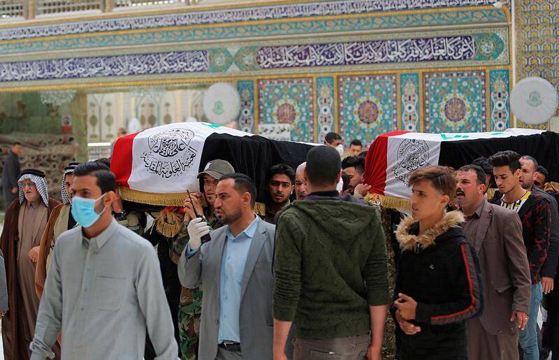Mourners carry the flag-draped coffins of two fighters of the Popular Mobilization Forces who were killed during the US attack against militants in Iraq, during their funeral procession at the Imam Ali shrine in Najaf, Iraq. AP Photo