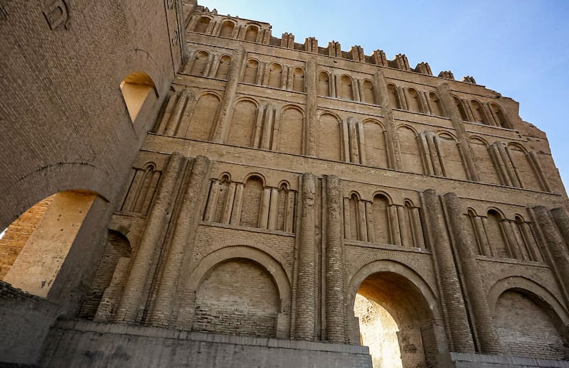 This picture taken on November 24, 2021 shows a view of the Arch of Ctesiphon, also known as Taq Kisra (Khosrow's Arch), stands before the conservators' scaffolding at the ancient site of Ctesiphon near moden al-Madain in central Iraq.  - The archaeological site, which houses the remnants of the former capital of the Persian Sassanid Empire until the Muslim Arab conquest in the 7th century AD, is currently undergoing restoration works to conserve the 1700-year-old arch.  The structure is "the largest single-span vault of unreinforced brickwork in the world".  (Photo by Sabah ARAR  /  AFP)