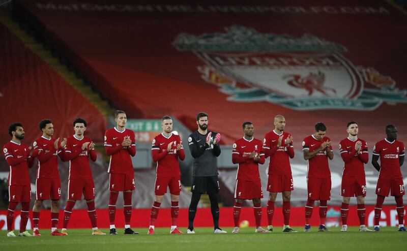 epa08889082 Liverpool players observe a minute applause in memory of former Liverpool manager Gerard Houllier during the English Premier League soccer match between Liverpool FC and Tottenham Hotspur in Liverpool, Britain, 16 December 2020.  EPA/Clive Brunskill / POOL EDITORIAL USE ONLY. No use with unauthorized audio, video, data, fixture lists, club/league logos or 'live' services. Online in-match use limited to 120 images, no video emulation. No use in betting, games or single club/league/player publications.