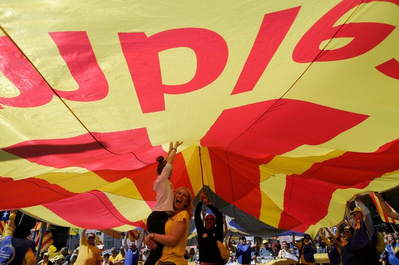 Catalans chanted "Freedom for the political prisoners" as they massed on the Parallel Avenue, one of the city's main streets, wearing yellow scarves, sweaters or jackets - tthe colour chosen to show solidarity with the jailed leaders. AP/Manu Fernandez