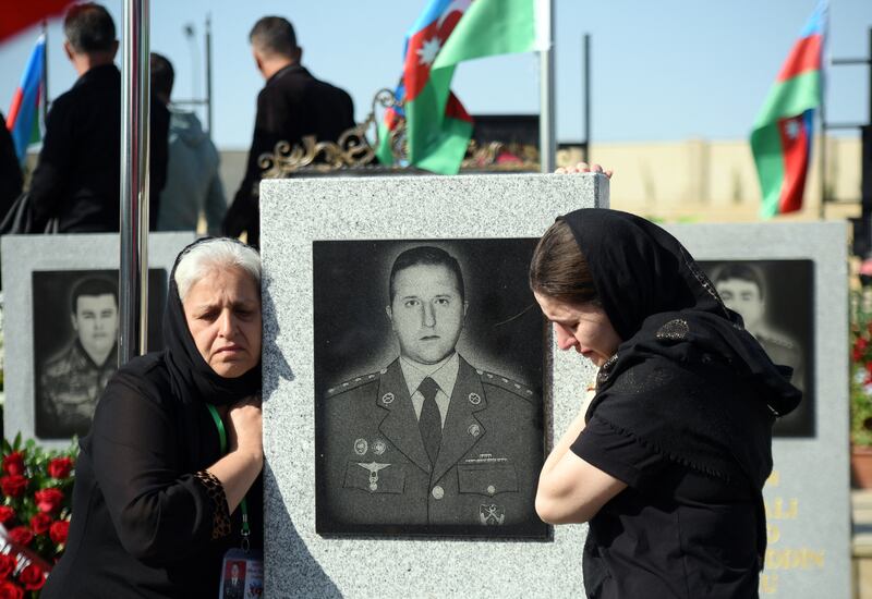 Mourning at a memorial cemetery in Baku, Azerbaijan. AFP