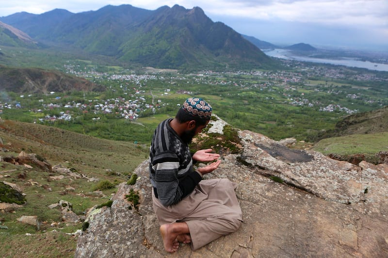 A Kashmiri Muslim man prays on a hill on the third day of fasting month of Ramadan on outskirts of Srinagar, the summer capital of Indian Kashmir. The religious authorities in Kashmir have urged people to pray the congregational Taravih (extended night prayers) and mandatory daily prayers at home to stop the spread of coronavirus in the region. Muslims around the world celebrate the holy month of Ramadan by praying during the night time and abstaining from eating, drinking, and sexual acts during the period between sunrise and sunset. Ramadan is the ninth month in the Islamic calendar.  EPA