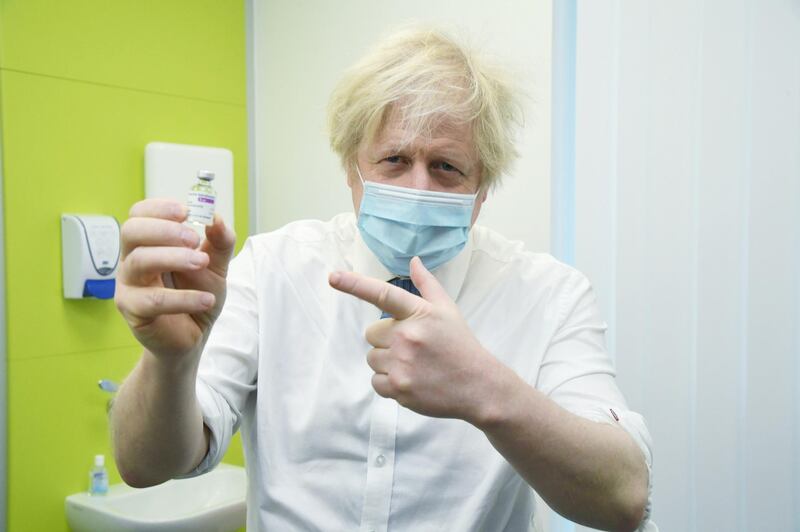 Britain's Prime Minister Boris Johnson holds a vial of AstraZeneca vaccine during a visit to a coronavirus vaccination centre in Orpington, South-East of London. Reuters