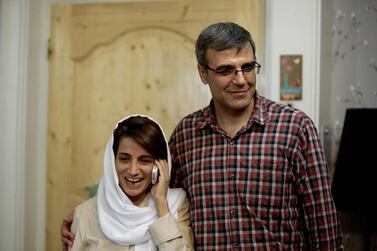 Iranian lawyer Nasrin Sotoudeh speaks on the phone next to her husband Reza Khandan as they pose for a photo at their house in Tehran. AFP