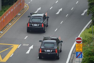 The motorcade carrying US President Donald Trump sets off to Sentosa, the resort island where Trump is scheduled to meet with North Korea's leader Kim Jong Un for a US-North Korea summit, in Singapore on June 12, 2018. Donald Trump and Kim Jong Un will make history on June 12, becoming the first sitting US and North Korean leaders to meet, shake hands and negotiate to end a decades-old nuclear stand-off. / AFP / Ted ALJIBE
