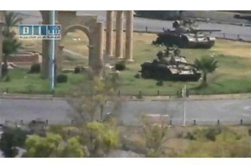 Tanks are seen stationed in the city of Hama in this still image taken from video posted on a social media website. Social Media Website via Reuters TV