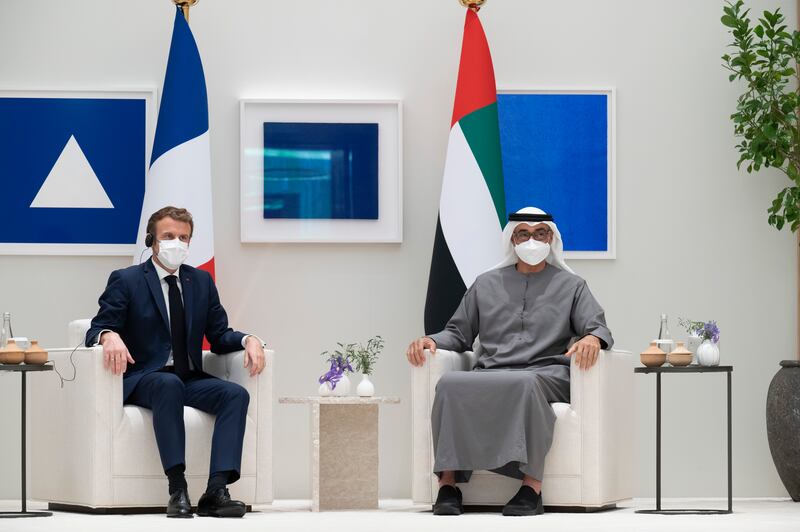 Sheikh Mohamed bin Zayed and President Emmanuel Macron witness a signing ceremony for various agreements. Photo: Ministry of Presidential Affairs