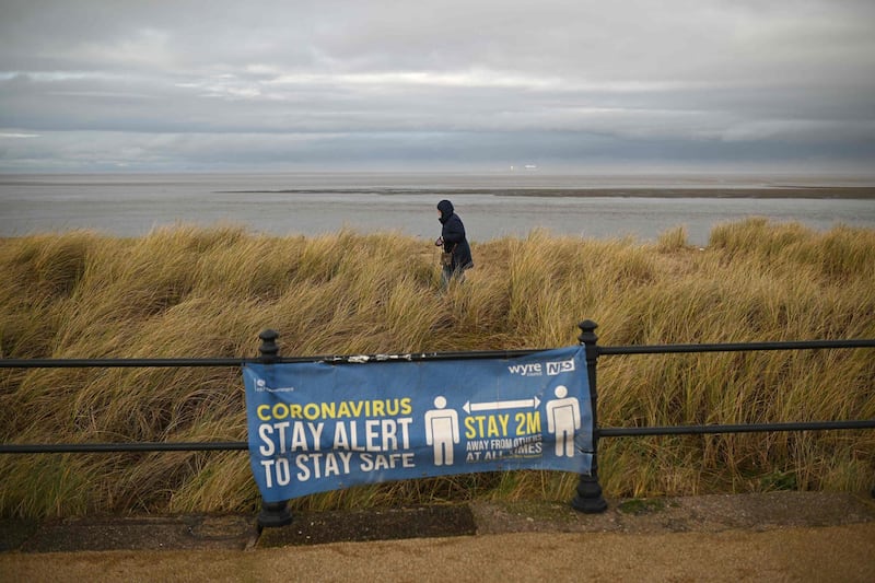 A sign reminding beach-users of the guidance to keep 2 metres away from other people is seen in Fleetwood, northwest England. AFP