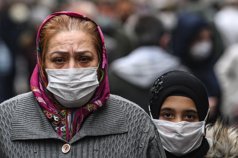People wearing face masks walk in the symp market in Gaziosmanpasa in Istanbul. AFP