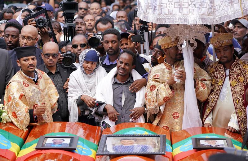ADDIS ABABA, ETHIOPIA - MARCH 17:  Family members of Captain Yared Getecho mourn in front of his coffin during a memorial service for the Ethiopian passangers and crew who perished in the Ethiopian Airways ET302 crash. All 157 passengers and crew perished after the Ethiopian Airlines Boeing 737 Max 8 Flight came down six minutes after taking off from Bole Airport. (Photo by Jemal Countess/Getty Images)