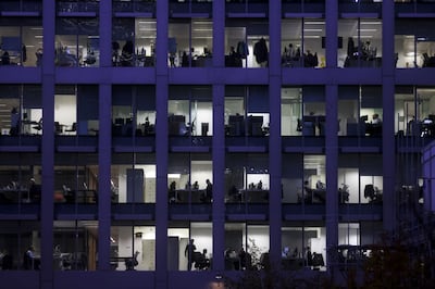 Employees work at their desks inside an office building in London. Many companies are sticking to hybrid working solutions rather than enforcing a full-time return to the office. Bloomberg