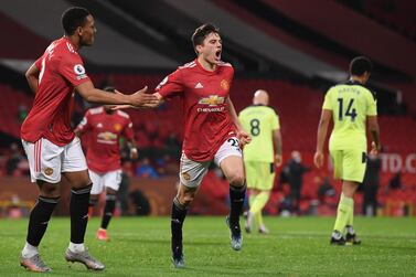 Manchester United's Daniel James, centre, celebrates after scoring his side's second goal during an English Premier League soccer match between Manchester United and Newcastle at the Old Trafford stadium in Manchester, England, Sunday Feb. 21, 2021. (Stu Forster/Pool via AP)