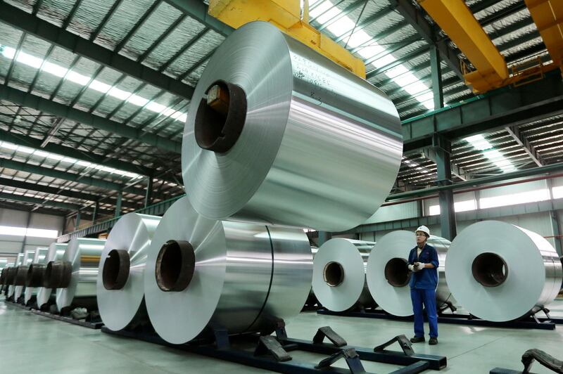 FILE - In this Aug. 3, 2017 file photo, a worker arranges the aluminum rolls at a factory in Suixi county in central China's Anhui province. Chinaâ€™s ruling Communist Party is expanding its role in business even as it promises freer markets and support for entrepreneurs on the eve of President Xi Jinpingâ€™s second five-year term as leader. The conflicting goals raise concerns that leaders might put off changes needed to reinvigorate a cooling economy that faces surging debt and trade tensions with Washington and Europe. (Chinatopix via AP, File)