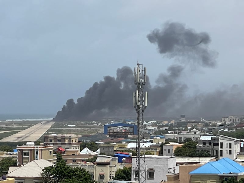 Smoke billows from a plane that flipped over after a crash landing in Mogadishu in this picture obtained from social media. Photo: Abdirahman Mohamed Arab via Reuters