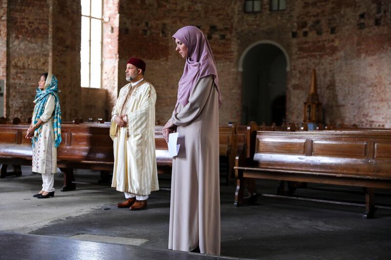 Members of various religions pray together at the Parochialkirche church in Berlin, Germany.  EPA
