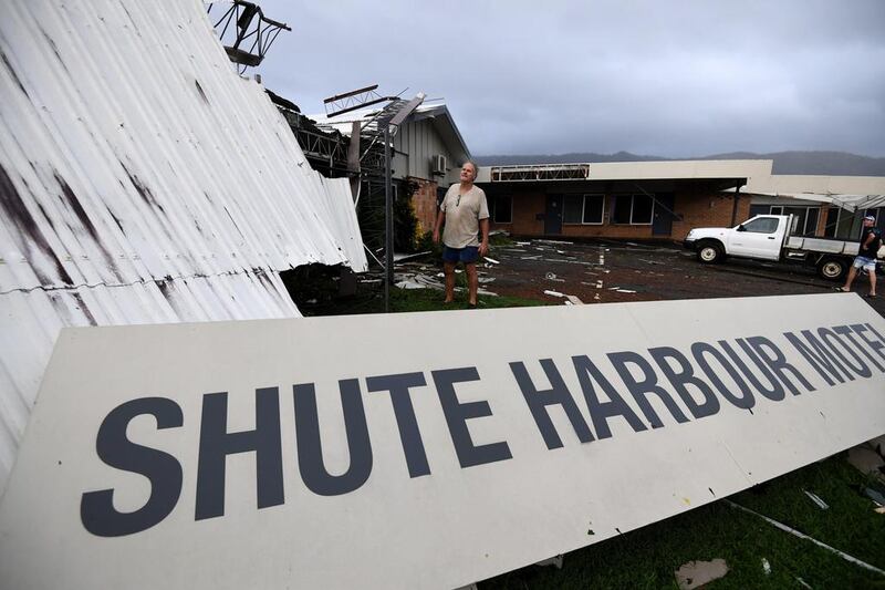 Dave Mcinnerney inspecting the damage to his motel at Shute Harbour near Airlie Beach. Tens of thousands of people moved to higher ground or cyclone shelters or left the region before Cyclone Debbie made landfall. Dan Paled/EPA