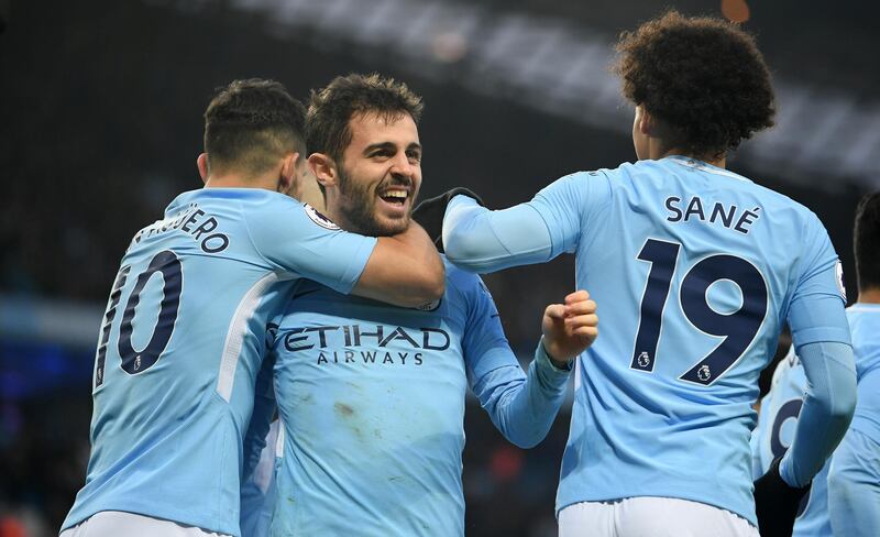 MANCHESTER, ENGLAND - MARCH 04: Bernardo Silva of Manchester City celebrates scoring his side's first goal with Sergio Aguero and Leroy Sane during the Premier League match between Manchester City and Chelsea at Etihad Stadium on March 4, 2018 in Manchester, England.  (Photo by Laurence Griffiths/Getty Images)