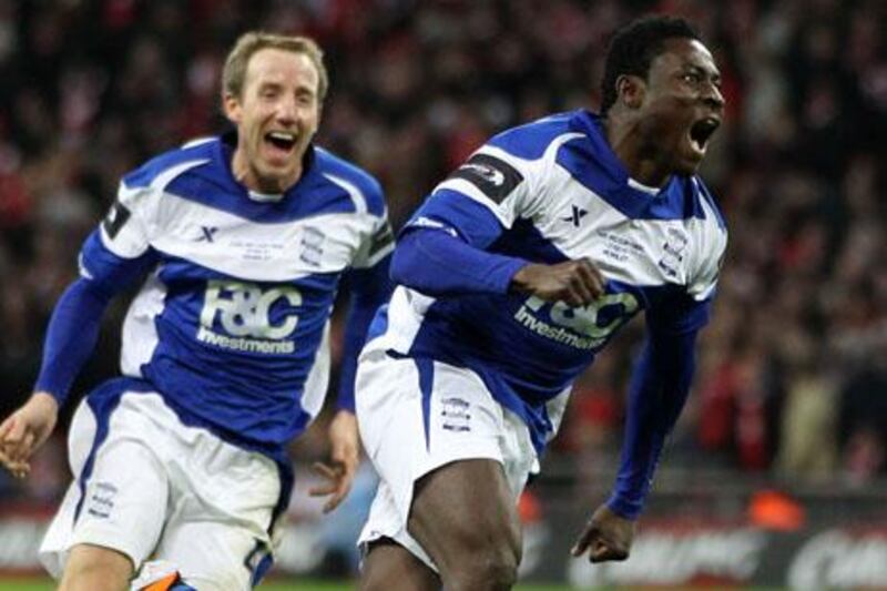 Birmingham City's Obafemi Martins (R) celebrates with teammate Birmingham City's English midfielder Lee Bowyer after scoring during the Carling Cup final football match between Arsenal and Birmingham at the Wembley Stadium in London on February 27, 2011. Birmingham City won 2-1.  AFP PHOTO/ADRIAN DENNIS

FOR EDITORIAL USE ONLY Additional licence required for any commercial/promotional use or use on TV or internet (except identical online version of newspaper) of Premier League/Football League photos. Tel DataCo +44 207 2981656. Do not alter/modify photo.

