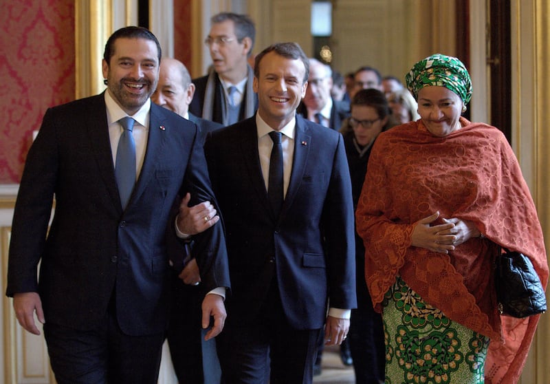 French President Emmanuel Macron walks between Saad Hariri and UN Deputy Secretary General Amina Mohammed, right, as they arrive to attend the Lebanon International Support Group meeting in Paris on December 8, 2017.