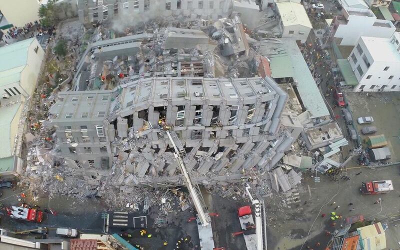 In this photo taken from a drone mounted camera, rescue workers search a collapsed building from an early morning earthquake in Tainan. The government in Tainan, the worst-hit city, said that more than 170 people had been rescued from the 17-story building. AP Photo