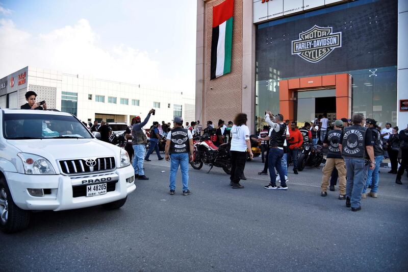 A car makes its way near bikers gathered for the 48th National Rally "Love Zayed" at the Harley Davidson showroom in Sharjah, UAE, Friday, Nov. 29, 2019. Shruti Jain The National
