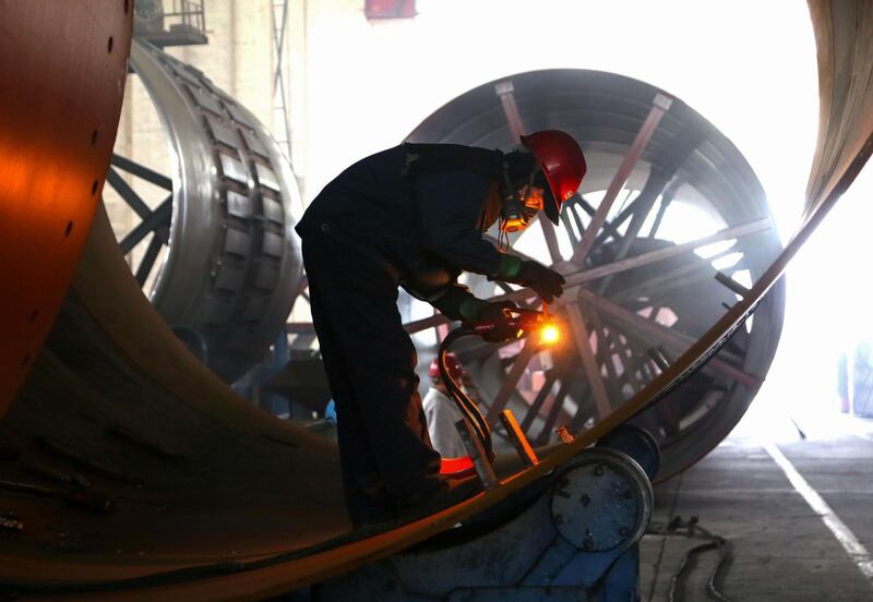 An employee works on rotary kiln parts at a factory in Haian, Jiangsu, China. AFP