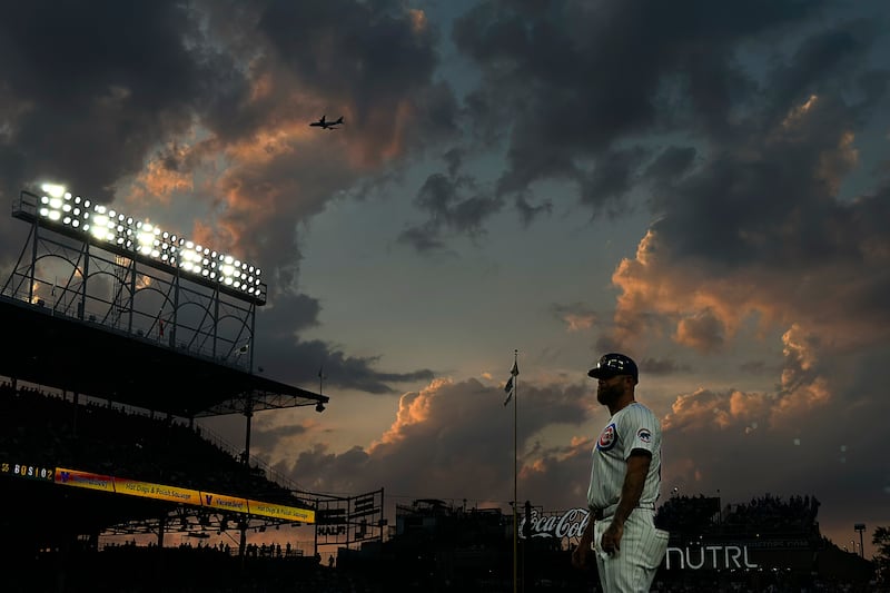 Chicago Cubs first base coach Mike Napoli looks into the stands during the fourth inning of a baseball game against the San Francisco Giants in Chicago. AP
