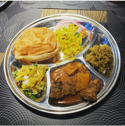 Chicken thali with cabbage, tamarind rice, spiced potatoes and puri. Photo: Shilpa Urva / Spice Tiffin