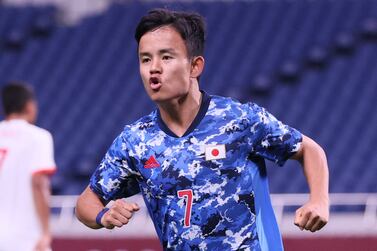 Japan's forward Takefusa Kubo celebrates after scoring the opening goal during the Tokyo 2020 Olympic Games men's group A first round football match between Japan and Mexico at Saitama Stadium in Saitama on July 25, 2021.  (Photo by Ayaka Naito  /  AFP)